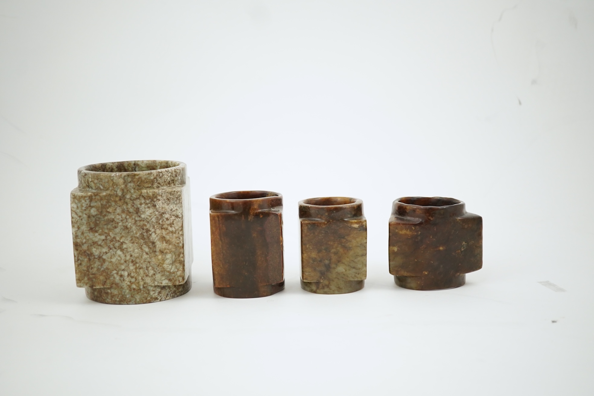 Four Chinese archaistic jade or hardstone cong